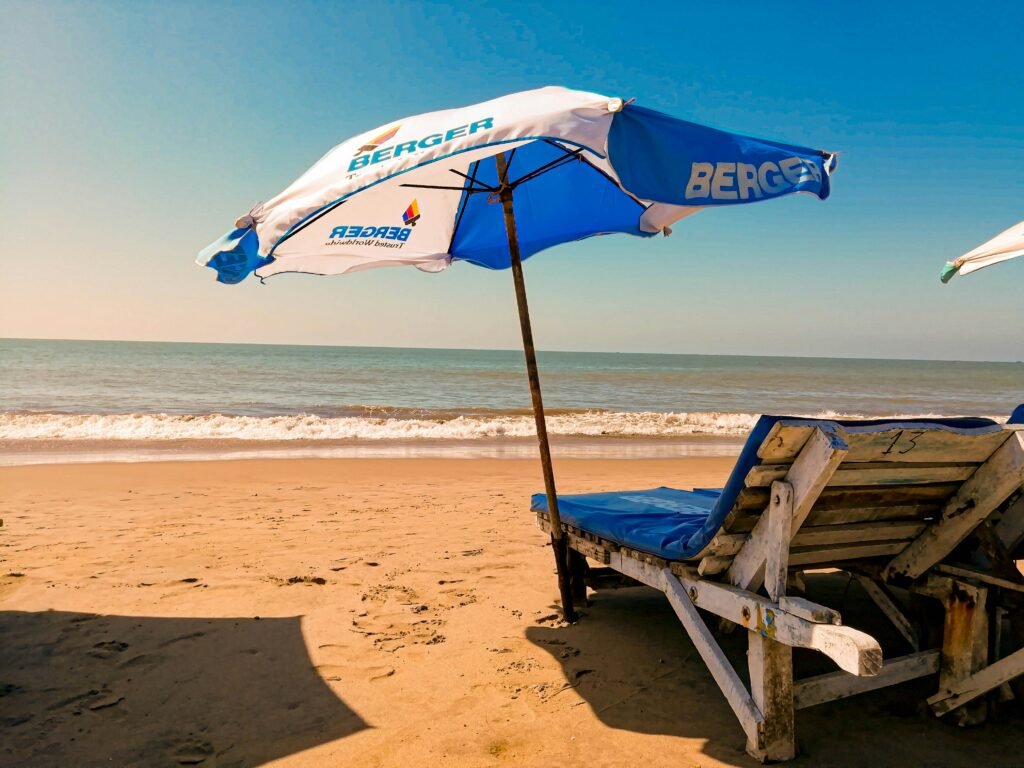 Wooden beach chair on the sand at Cox's Bazar, Bangladesh, evoking a relaxing coastal stay